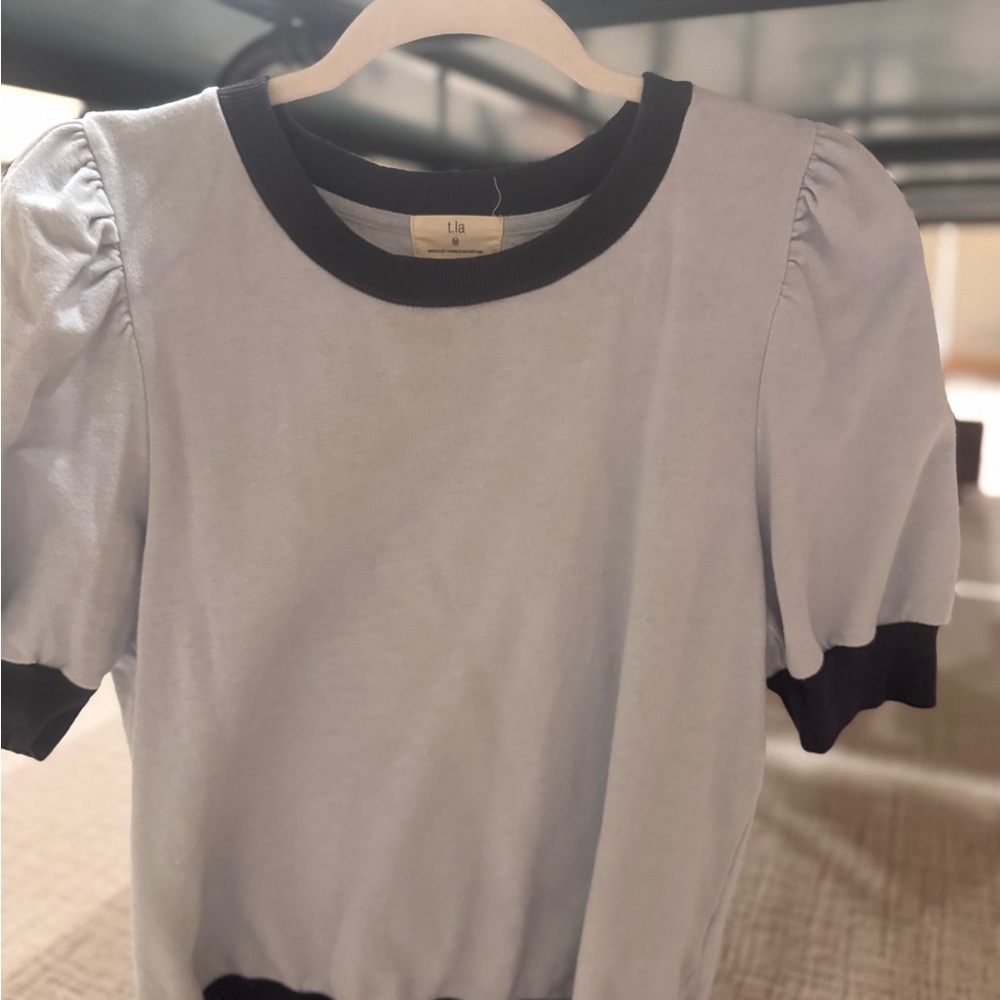 ANTHROPOLOGIE: LIGHT BLUE SHIRT WITH NAVY TRIM.